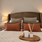Ivy & Sage Eucalyptus Mint ceramic candle styled with home fragrance products in a warm, cosy bedroom.