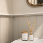 Ivy & Sage Eucalyptus Mint glass candle and reed diffuser styled together in a neutral home interior.