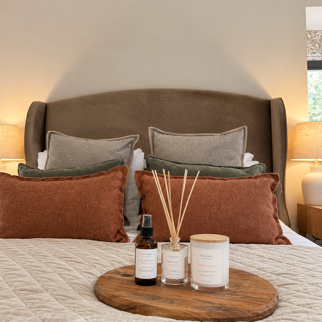 Ivy & Sage Maldives glass candle styled with home fragrance products in a warm, cosy bedroom.