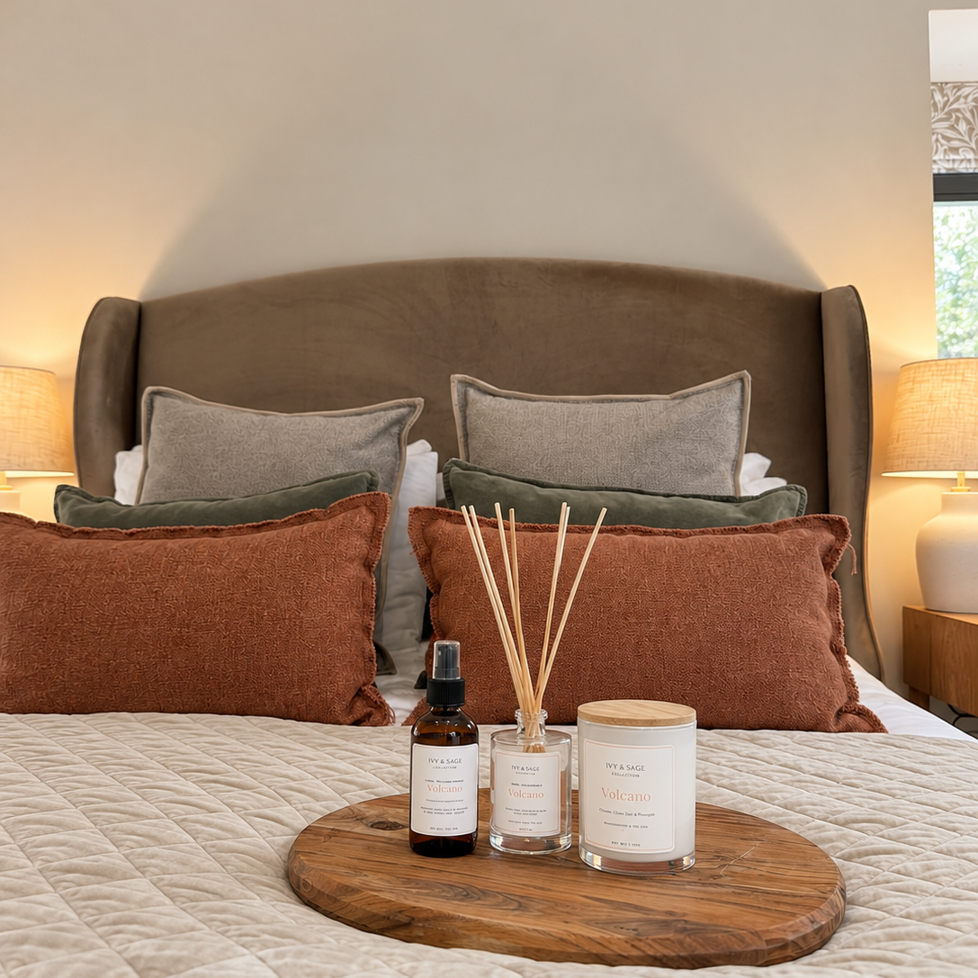 Ivy & Sage White Tea glass candle styled with home fragrance products in a warm, cosy bedroom.