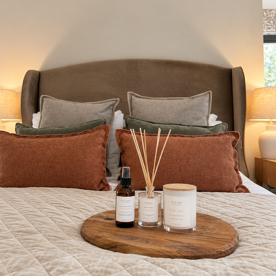 Ivy & Sage  reed diffuser styled in a warm, neutral bedroom alongside coordinating home fragrance products.