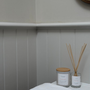 Ivy & Sage  reed diffuser and candle styled together in a modern neutral home interior.