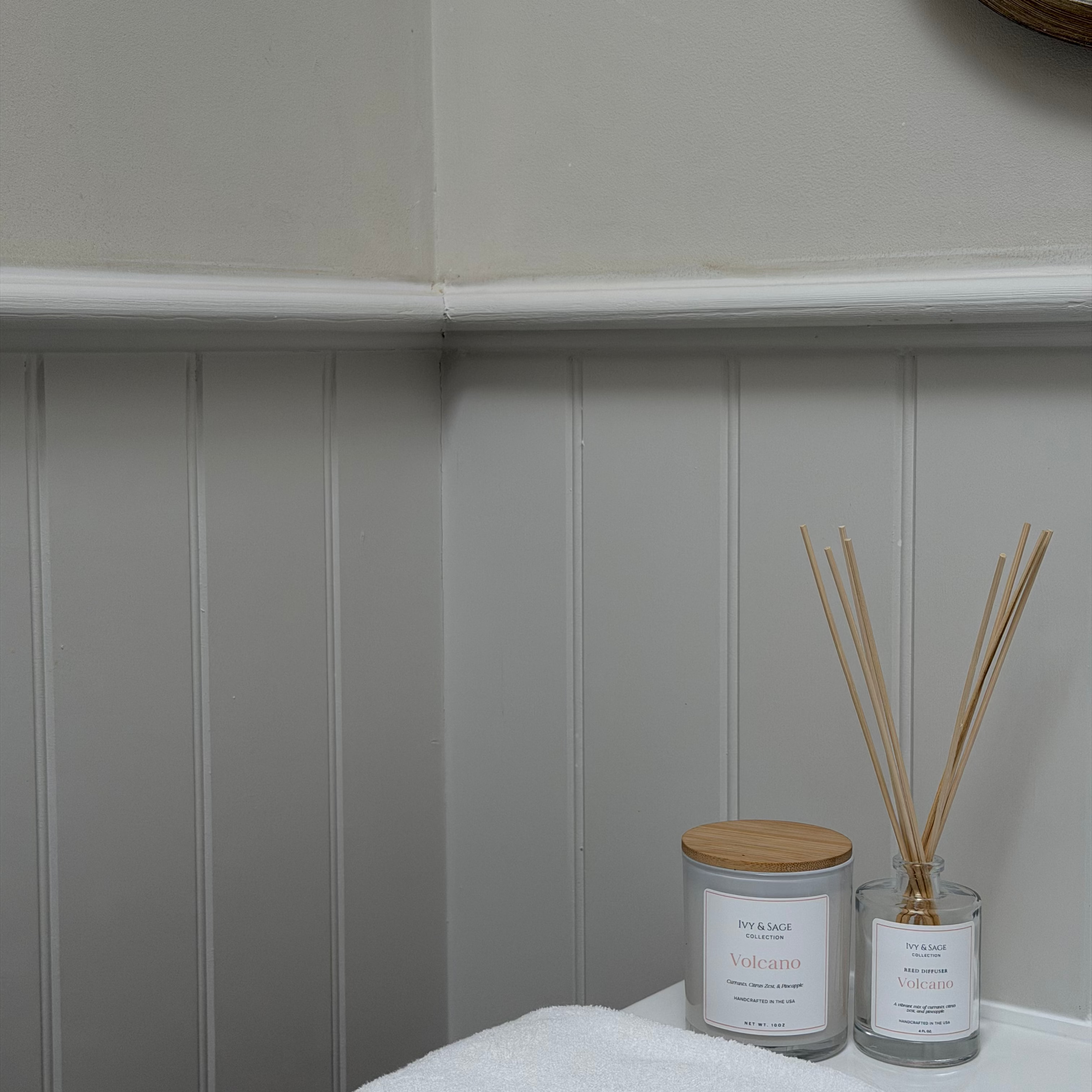 Ivy & Sage  reed diffuser and candle styled together in a modern neutral home interior.