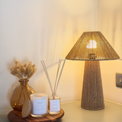 Ivy & Sage reed diffuser styled with home fragrance products beside a warm table lamp in a neutral home interior.