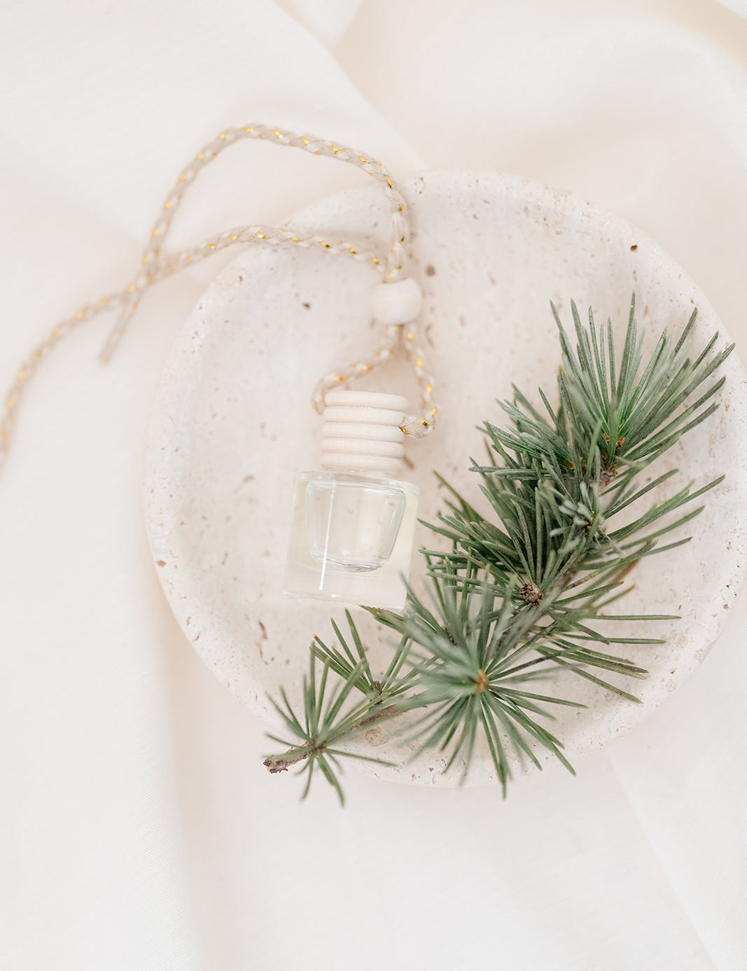 Car Diffuser with greenery on a white background in a marble bowl