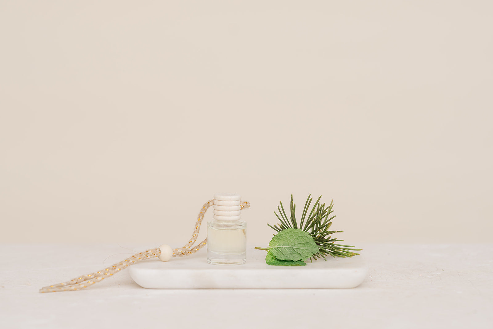 Glass bottle car diffuser on marble slab in the scent Snow Day