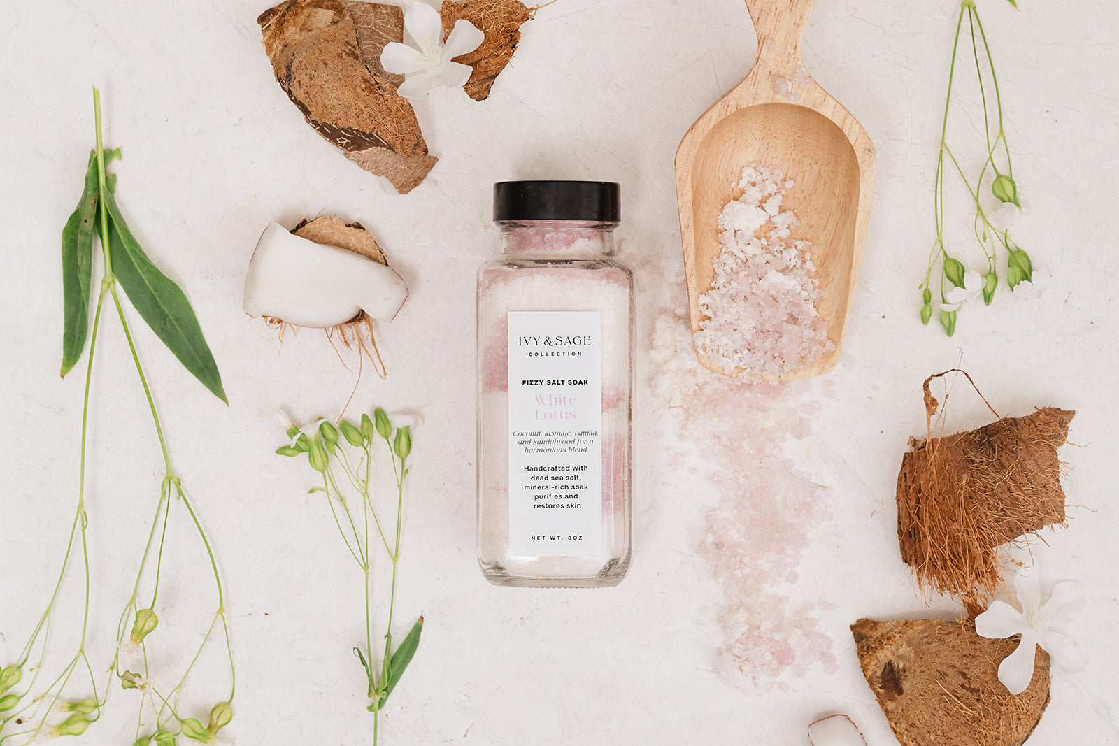 Salt Soak on white background with coconut and spilled salts on spoon