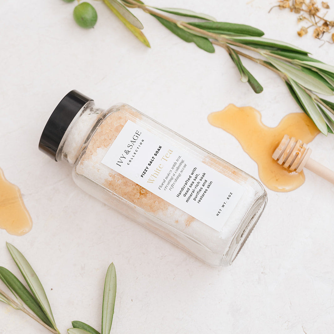 Bottle of Bath salts with honey on a light background for White Tea Scent