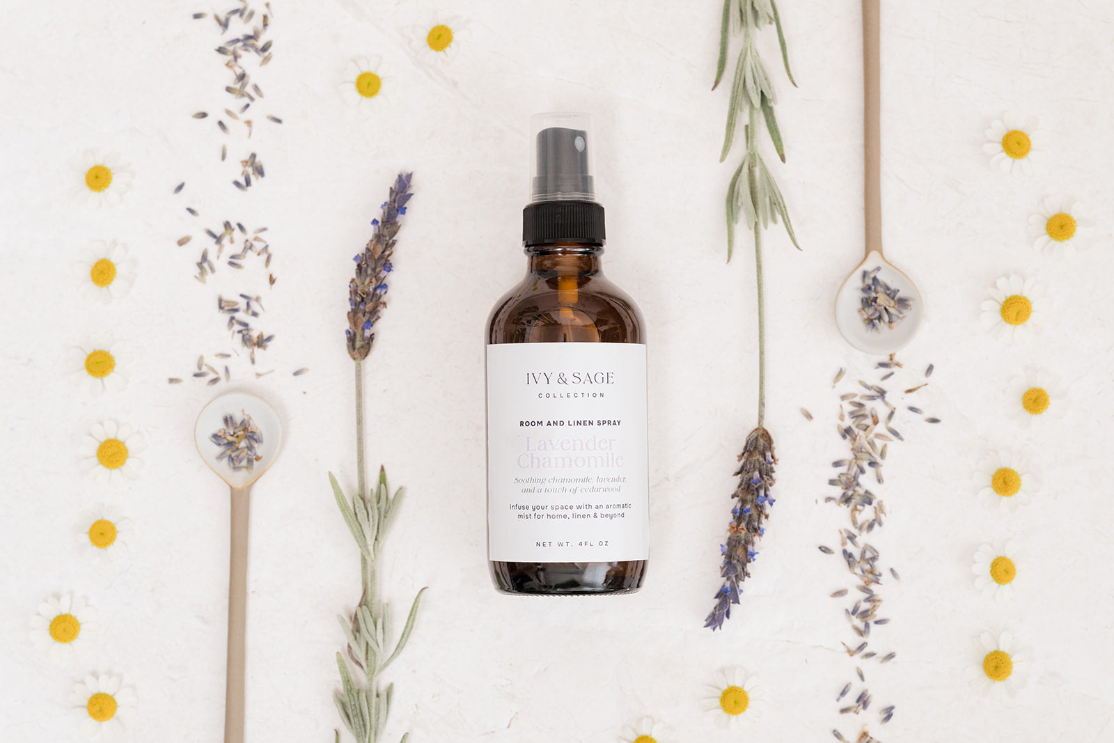 Bottle of Room & Linen Spray bottle with lavender flowers as a flat lay