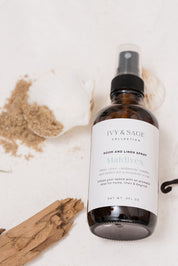 Room and linen spray bottle with 'Ivy & Sage' label on a light background