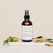 Room & Linen Spray with honey and white tea on white marble slab