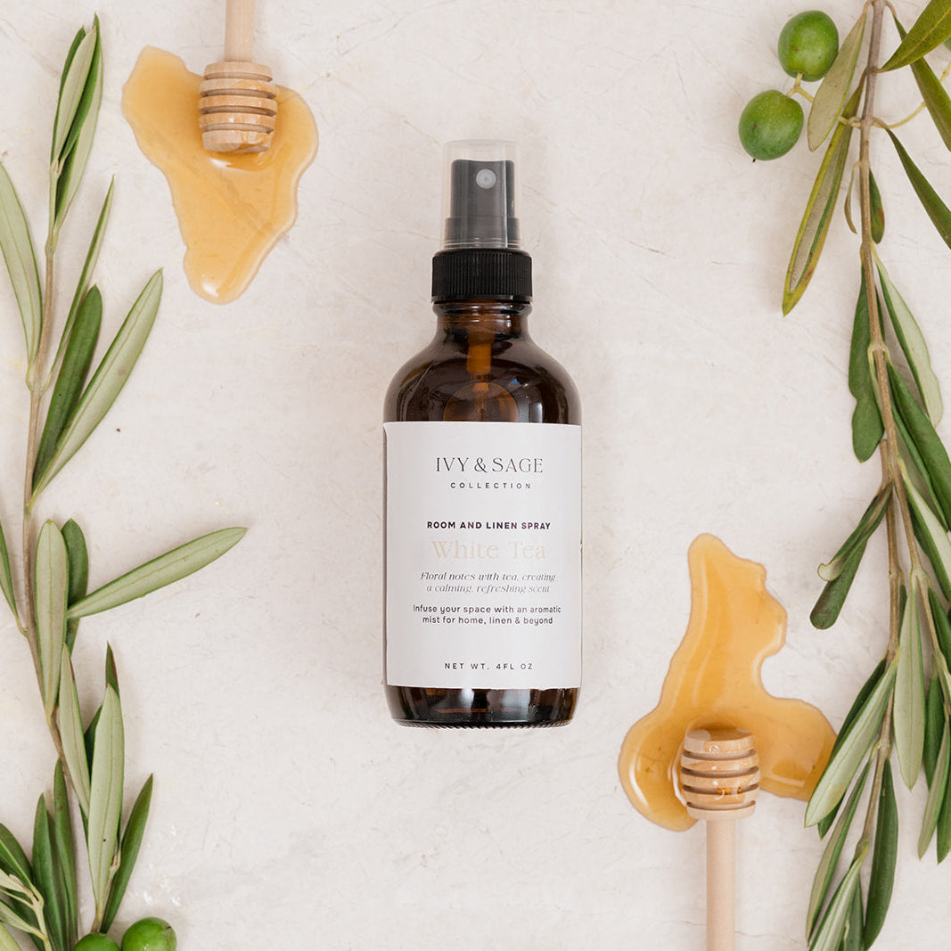 Room & Linen Spray with honey and white tea on beige background