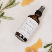 Room & Linen Spray with honey on background