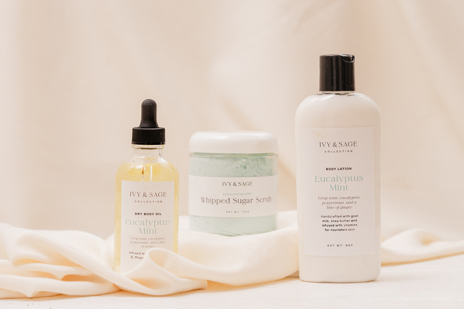 IVY & SAGE Body Oil, Sugar Scrub and Lotion on a soft beige background