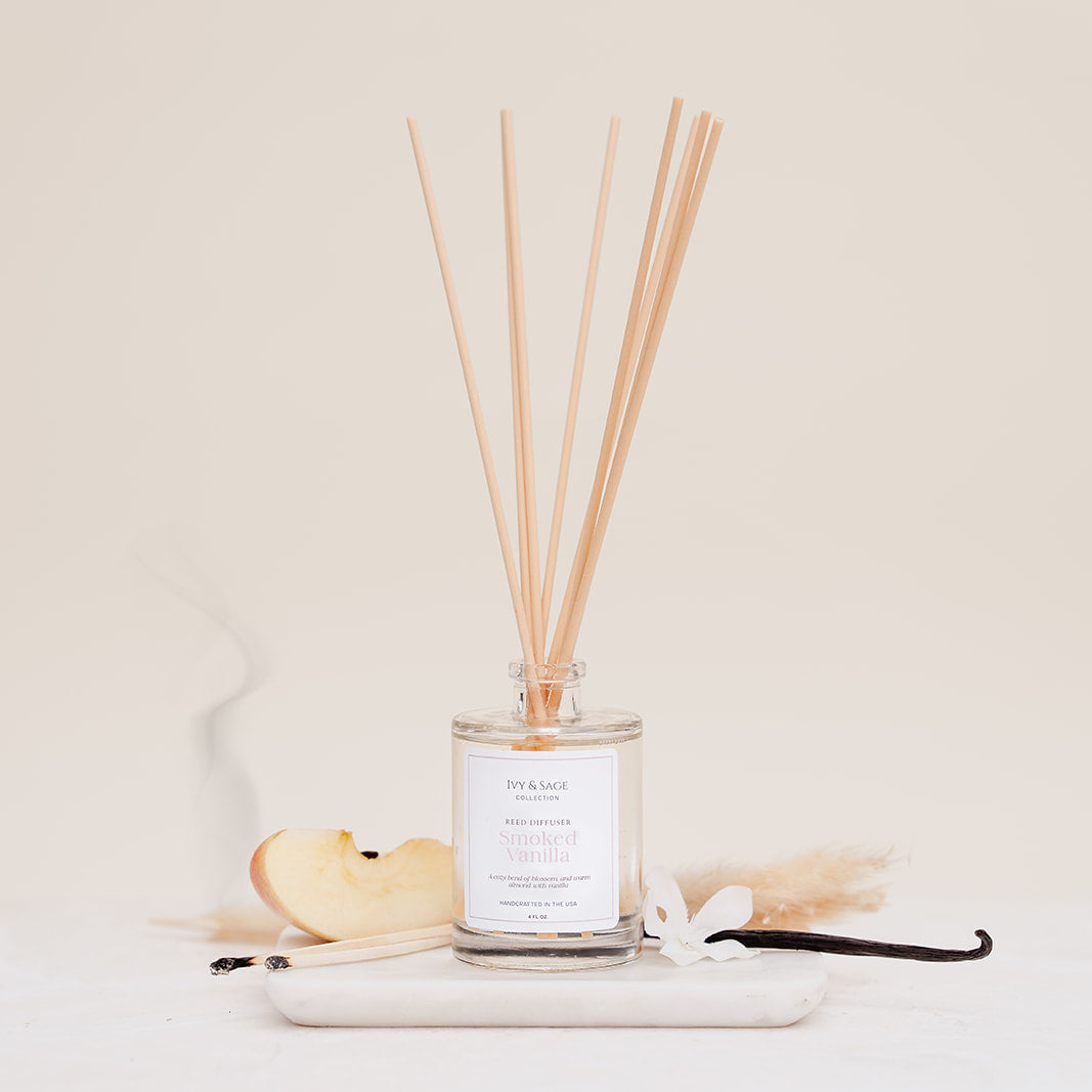Ivy & Sage Smoked Vanilla reed diffuser with natural reeds, styled with vanilla, apple and warm botanical details on a neutral background.”