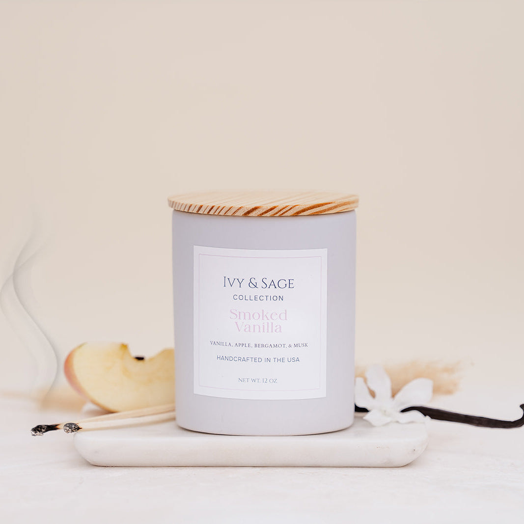 Ivy & Sage Smoked Vanilla ceramic candle with wooden lid, styled with vanilla, apple and soft smoky details.