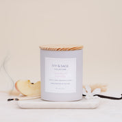Ivy & Sage Smoked Vanilla ceramic candle with wooden lid, styled with vanilla, apple and soft smoky details.