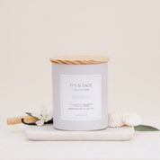 Ivy & Sage Maldives ceramic candle with wooden lid, styled with soft coastal-inspired details.