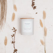 Ivy & Sage Eucalyptus Mint ceramic candle styled in a neutral botanical flat lay.
