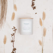 Ivy & Sage Lavender & Chamomile ceramic candle styled in a neutral botanical flat lay.
