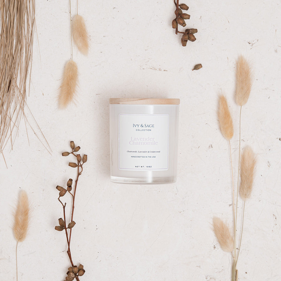 Ivy & Sage Lavender & Chamomile glass candle flat lay styled with soft neutral botanicals.