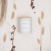 Ivy & Sage Santal 13 ceramic candle flat lay styled with neutral botanical and woody details.
