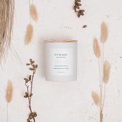 Ivy & Sage White Tea ceramic candle flat lay styled with soft neutral botanicals and natural details.