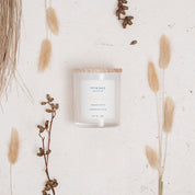 Ivy & Sage White Tea glass candle flat lay styled with soft neutral botanicals and natural details.